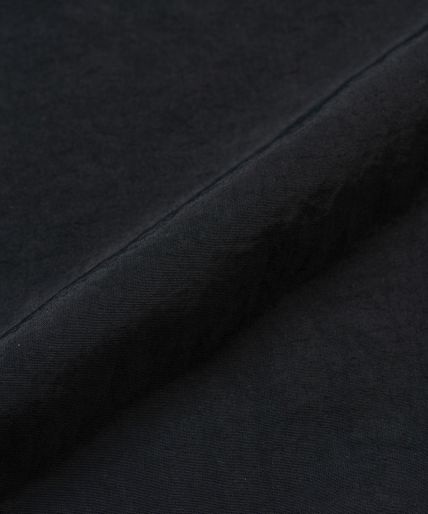 Close-up of Gramicci black nylon trek pants fabric texture
