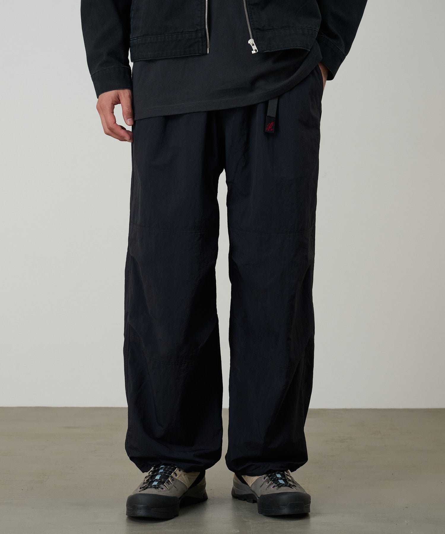 Model wearing Gramicci black nylon trek pants outdoors