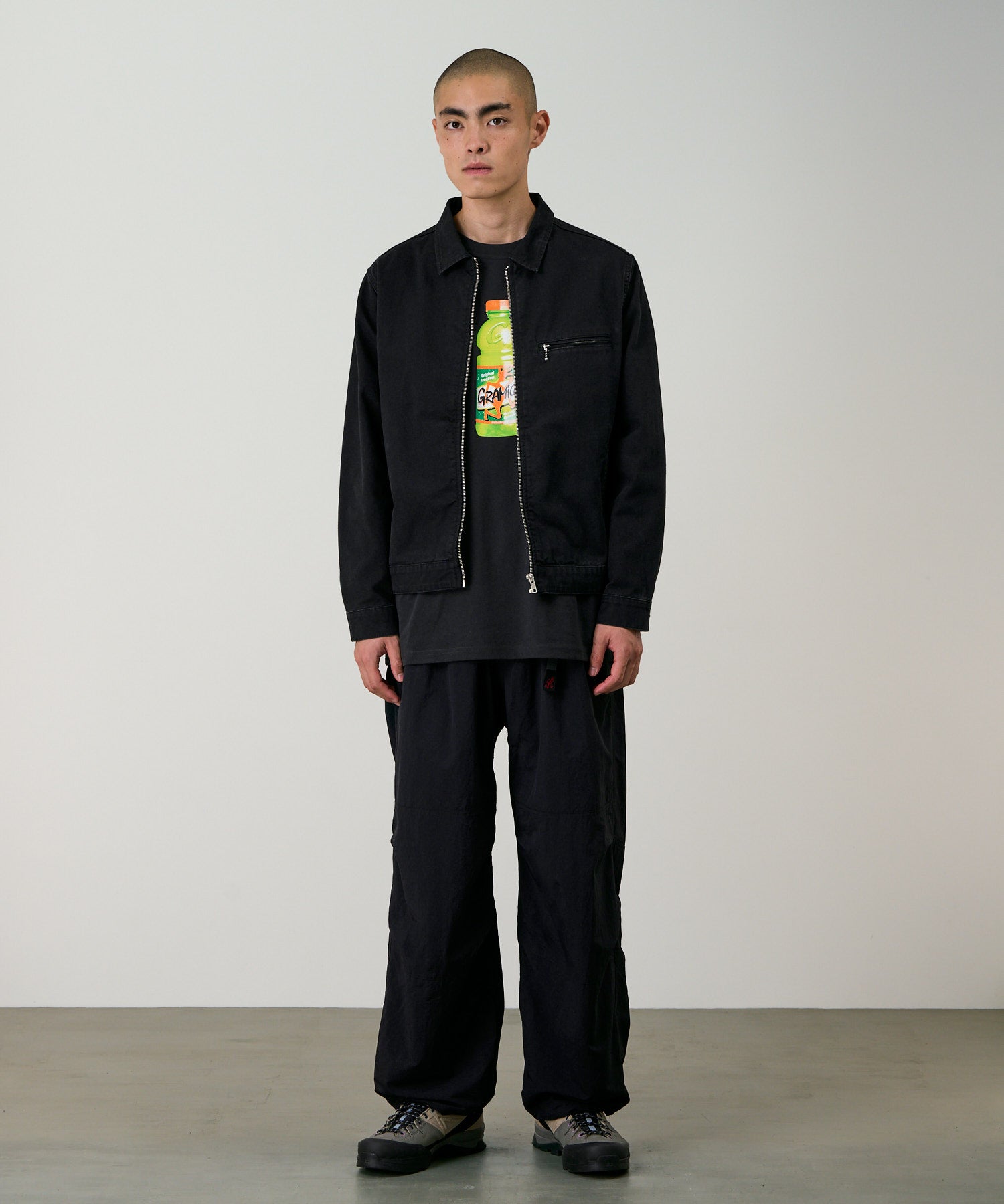 Model wearing Gramicci black nylon trek pants standing outdoor