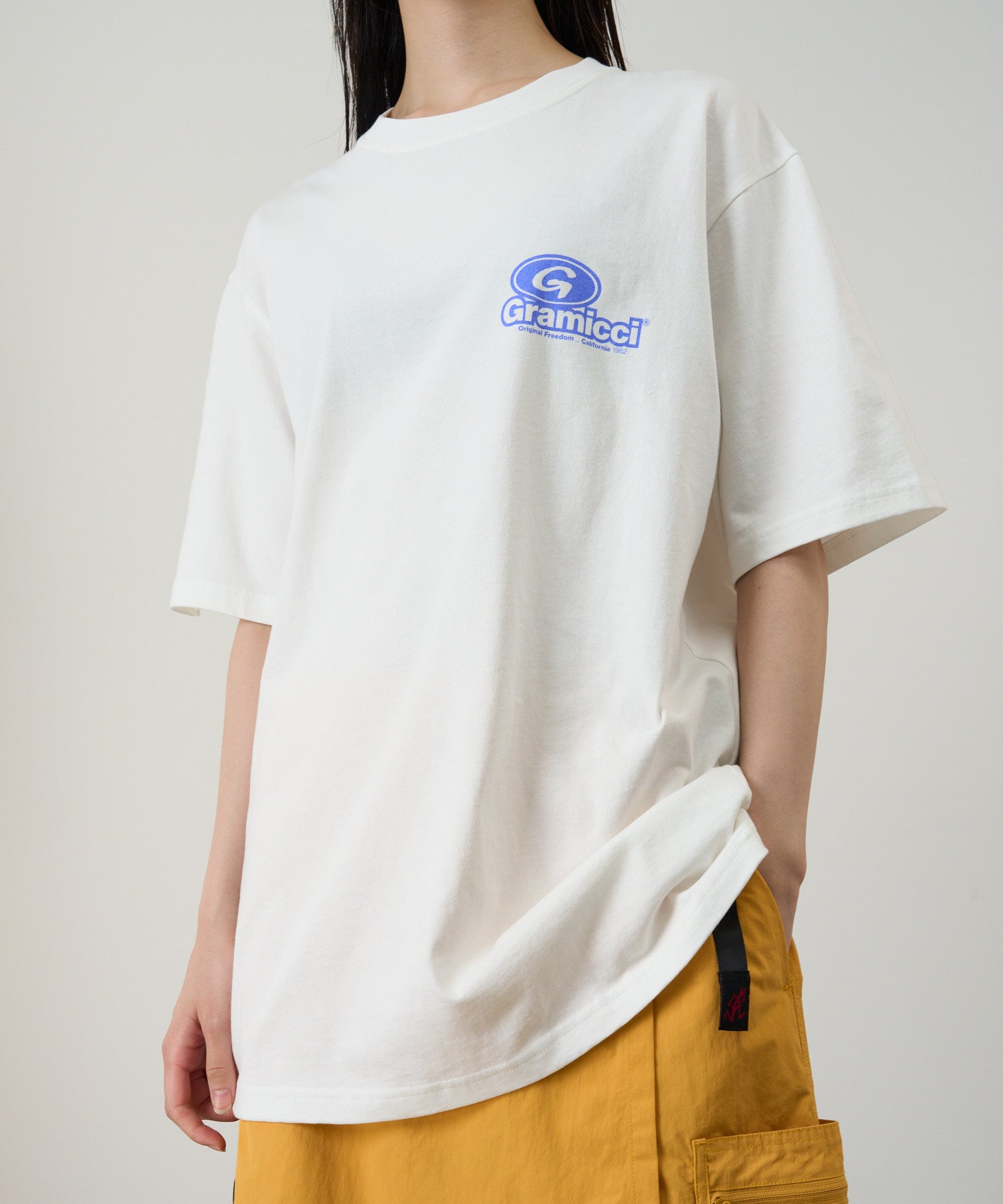 Model wearing Gramicci ’82 Tee White eco cotton graphic T-shirt