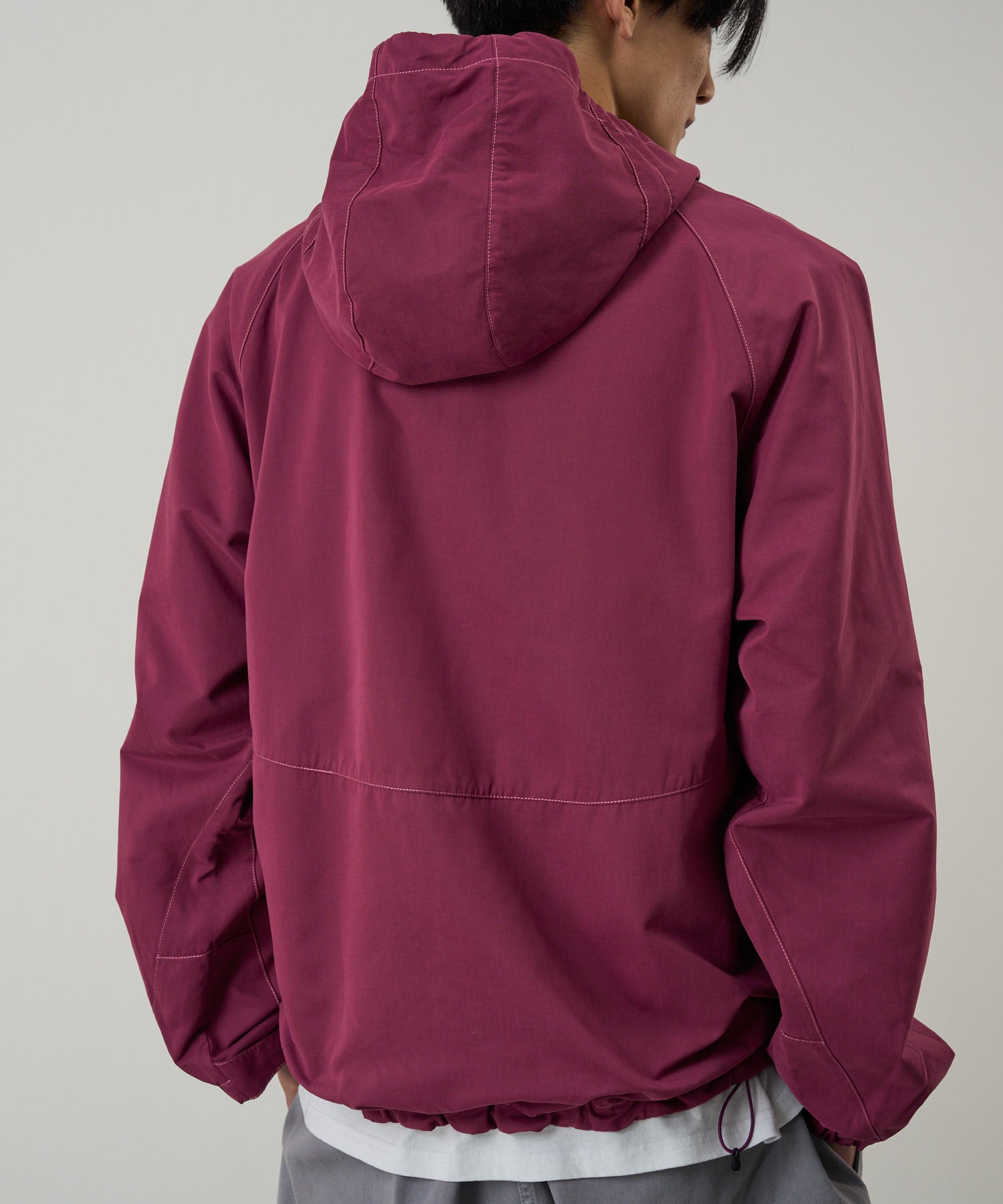 Gramicci burgundy pants on body side angle showing comfort and movement