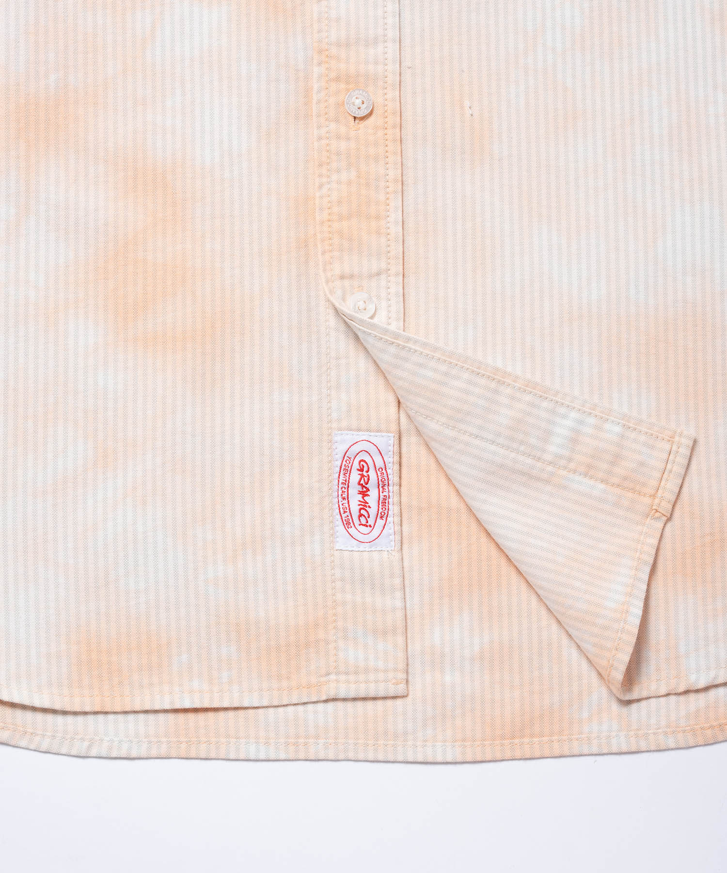 Close-up of Gramicci checkered ombre shirt mustard stripe showing breathable fabric texture and stitching detail