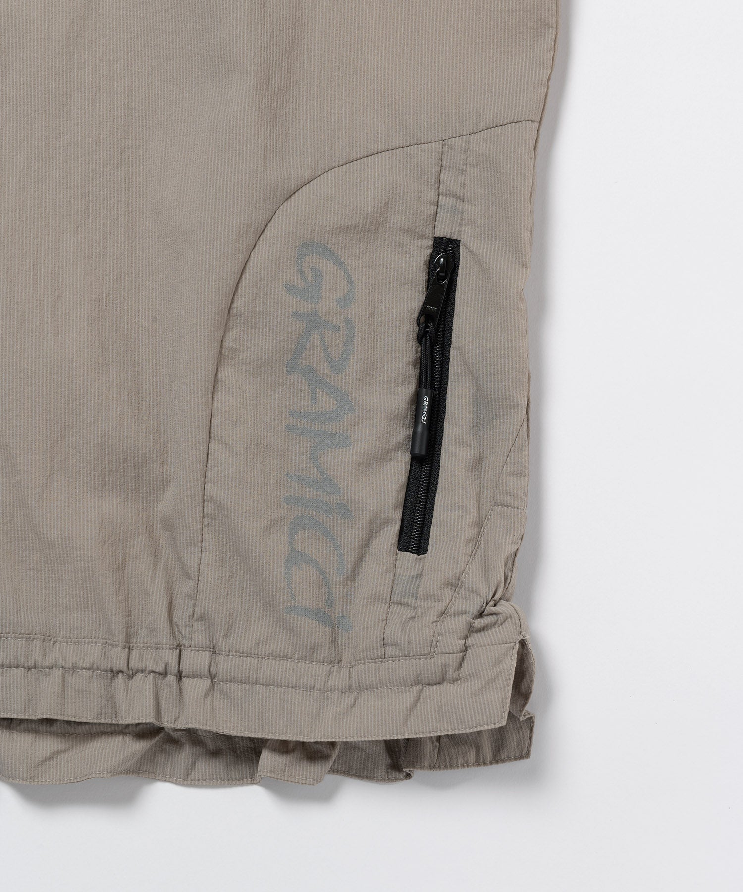 Close-up of Gramicci concrete jacket showing fabric weave, stitching and material detail