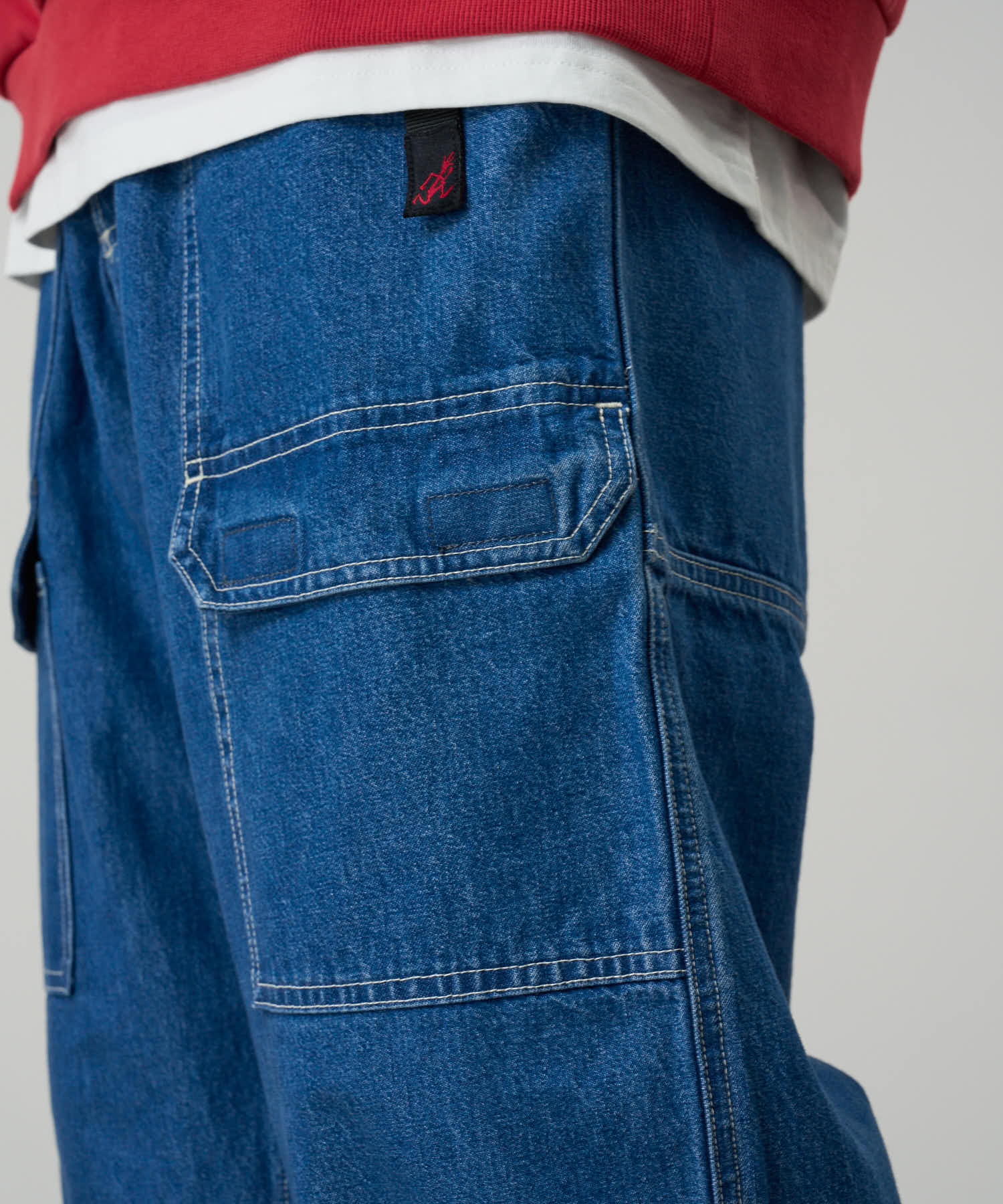 Gramicci denim EQT light wash pants on body side angle showing comfort and flexibility