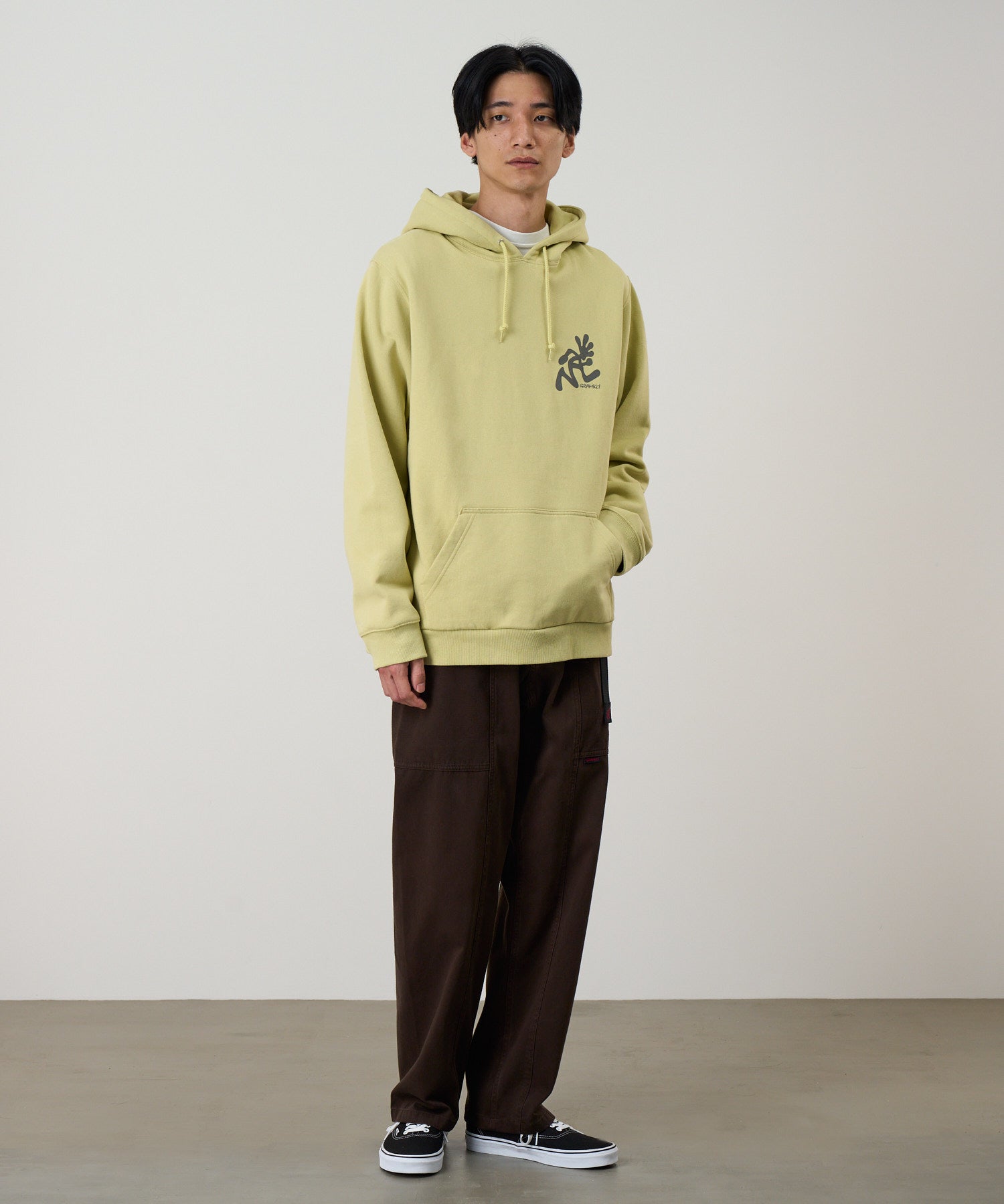 Gramicci Running Man hoodie in lime green – relaxed fit outdoor sweatshirt on model front view