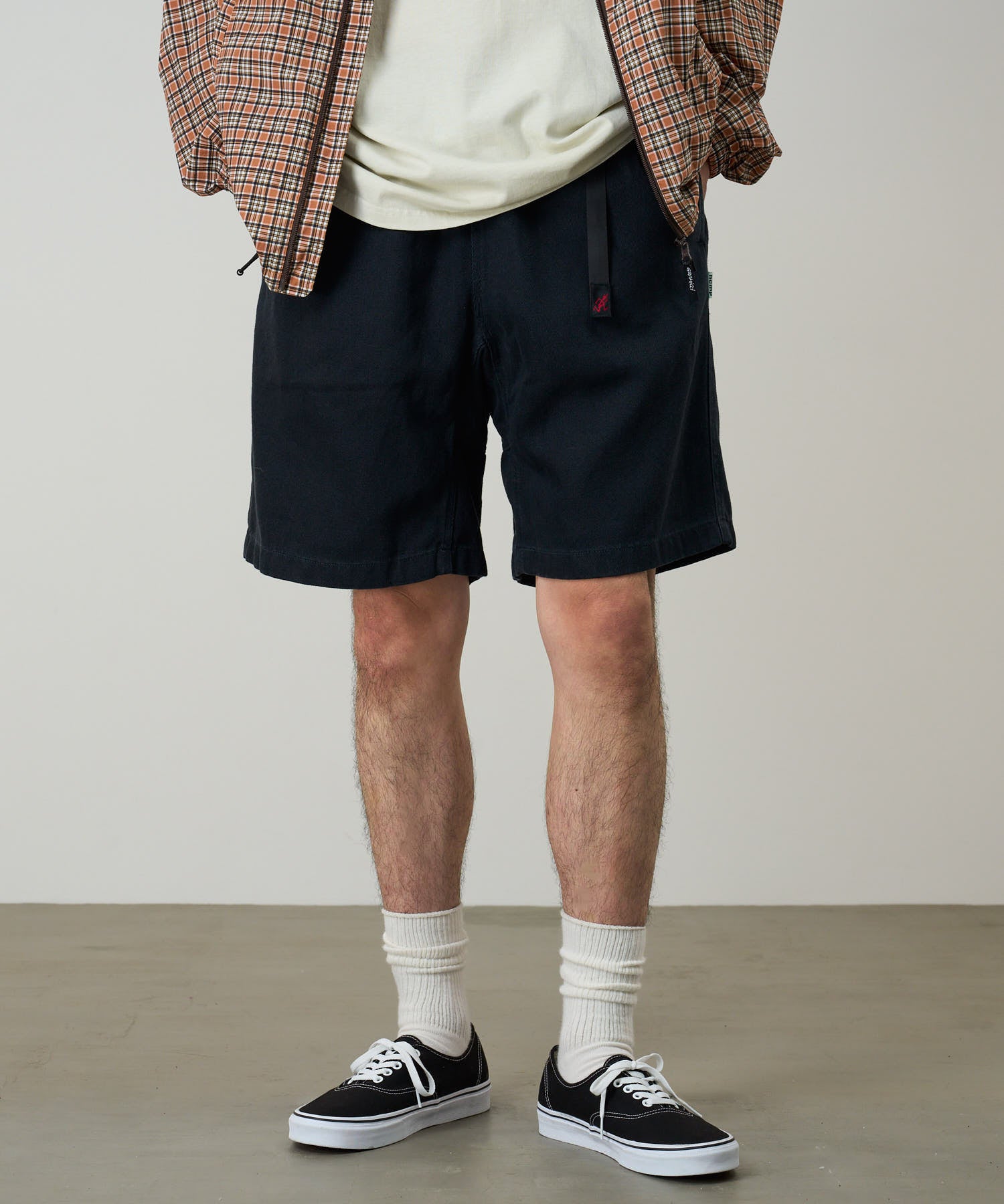 Model wearing Gramicci Nylon Explorer Cargo Shorts Carbon relaxed fit outdoor shorts lifestyle front view