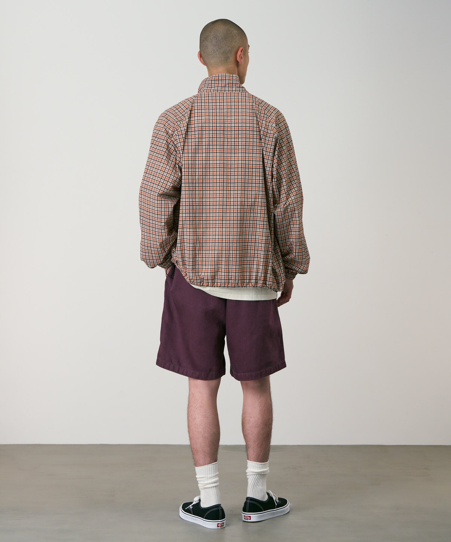 Back view of model wearing Gramicci Nylon Explorer Cargo Shorts Deep Grape relaxed outdoor shorts utility fit