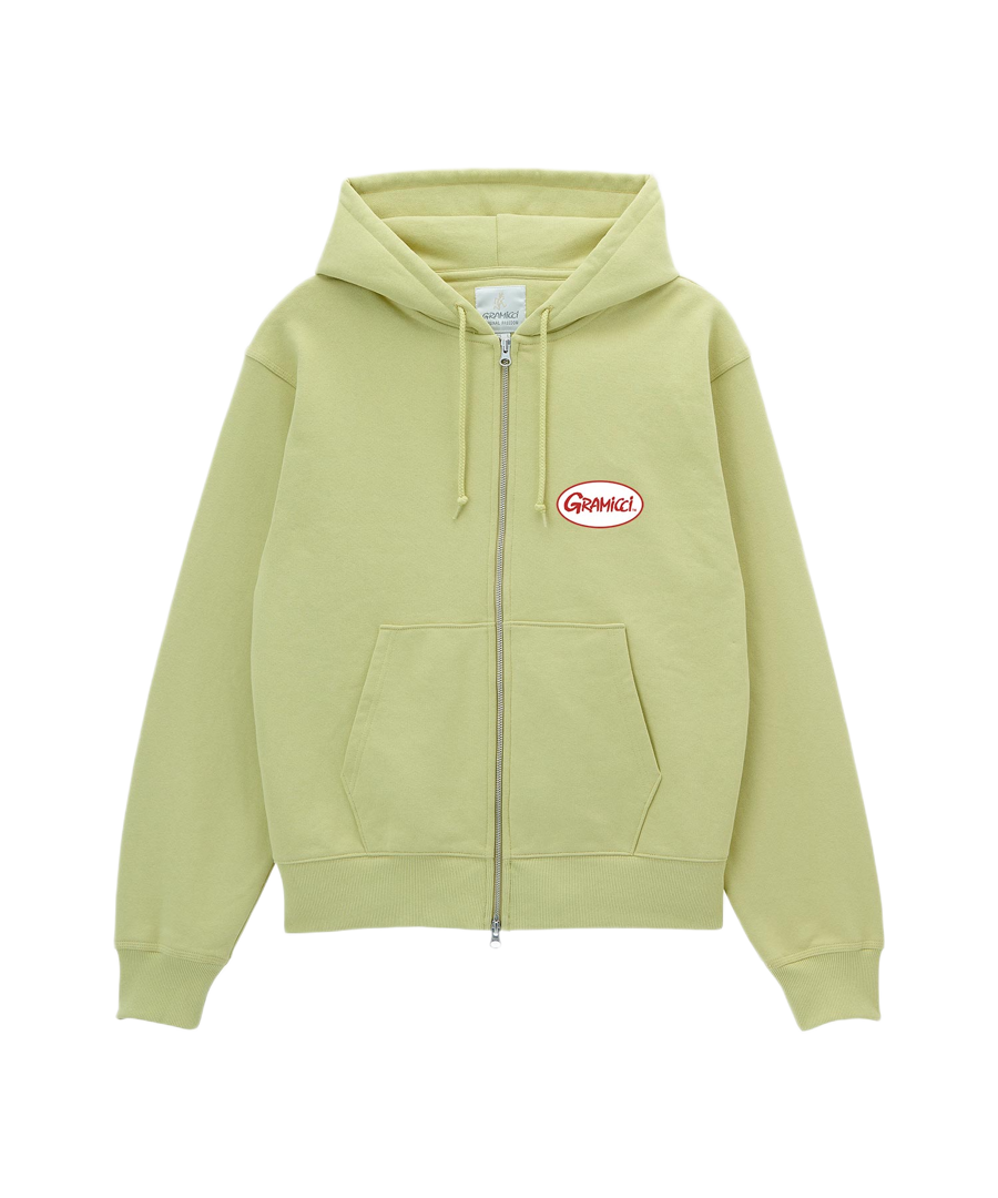 Gramicci Oval Patch Zip Hooded Sweatshirt Lime crafted from a soft cotton fleece blend with a full zip, drawstring hood and everyday comfort.