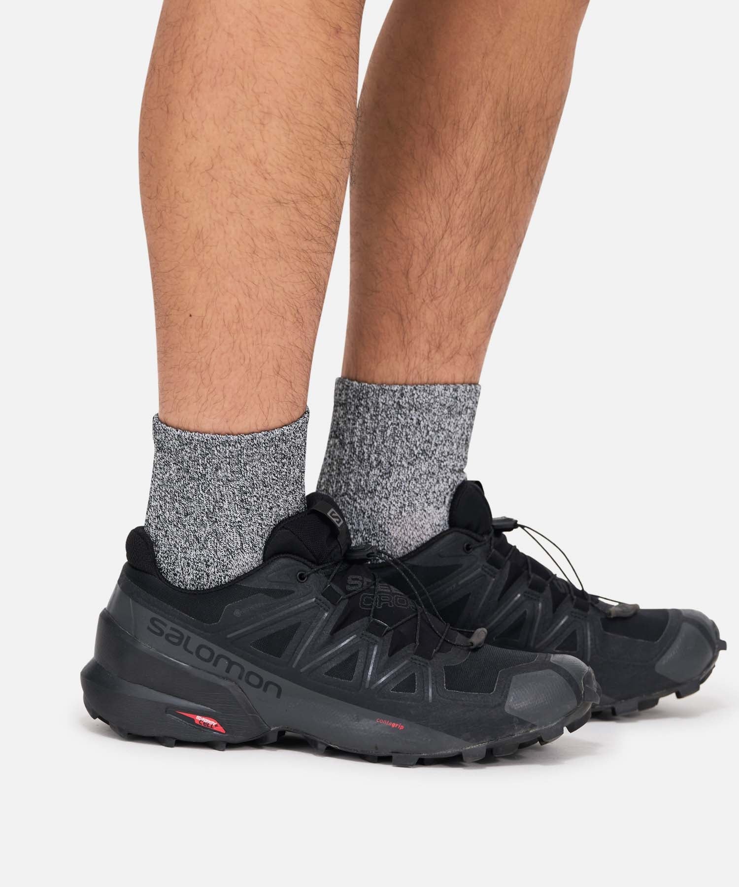 Model wearing Gramicci Paper Mix Short Socks Black with breathable paper blend fabric for lightweight everyday comfort and casual wear.
