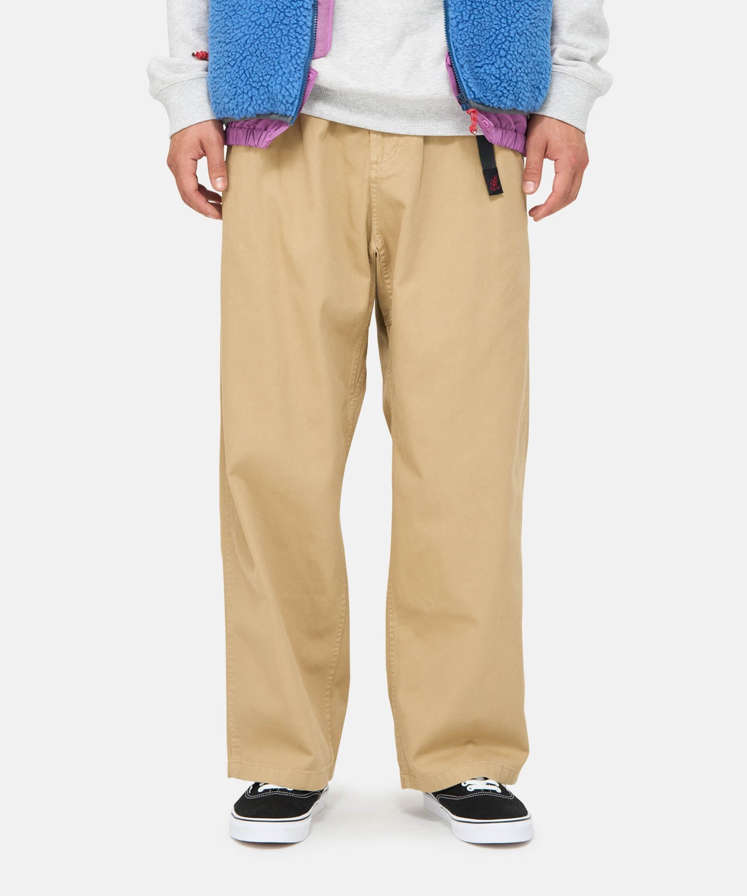 Back view of model wearing Gramicci Wide Pant Dune Pigment featuring a relaxed wide-leg fit, integrated webbing belt and durable eco cotton twill.