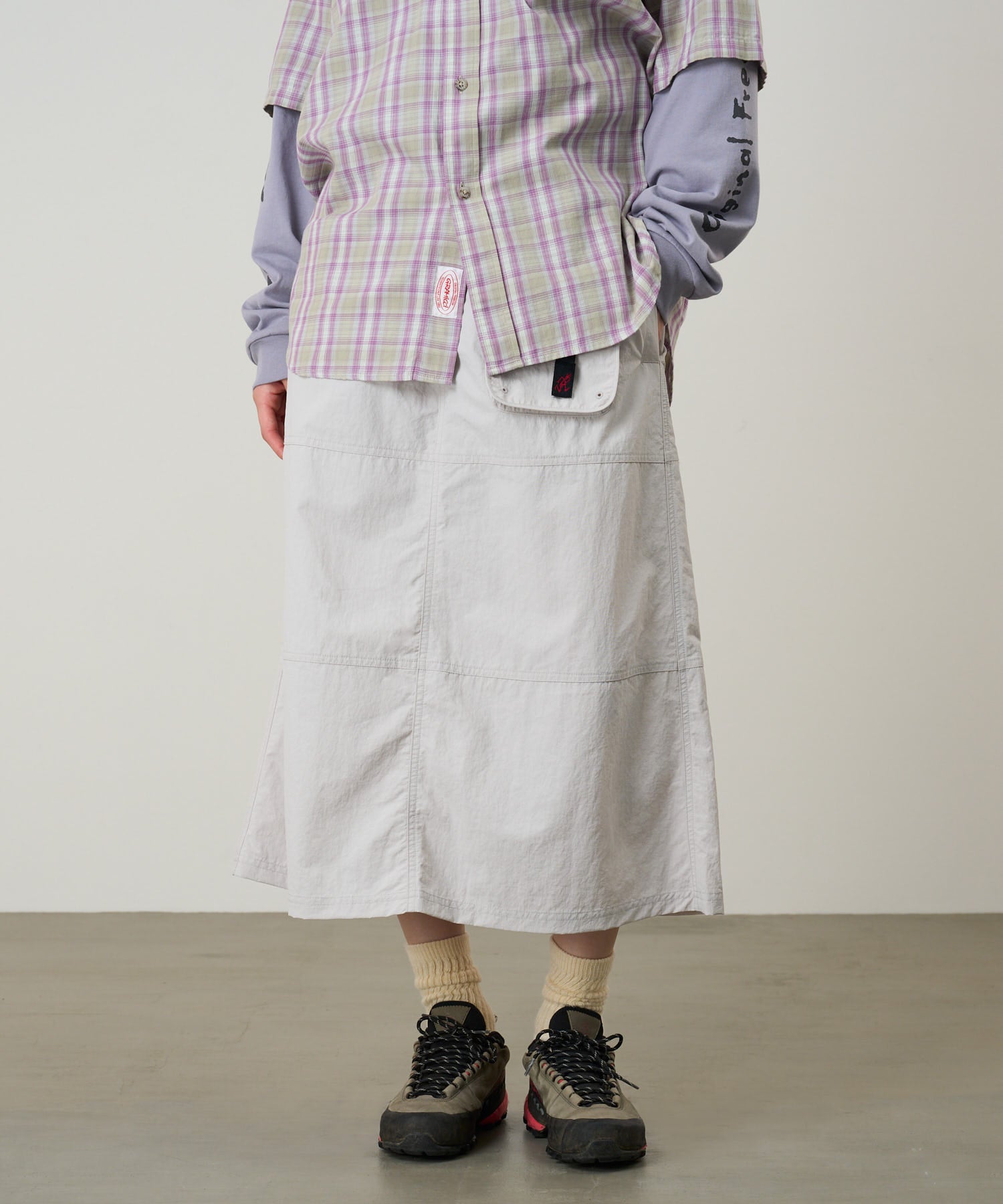 Model wearing Gramicci Nylon Utility Skirt Ecru water-resistant recycled nylon skirt