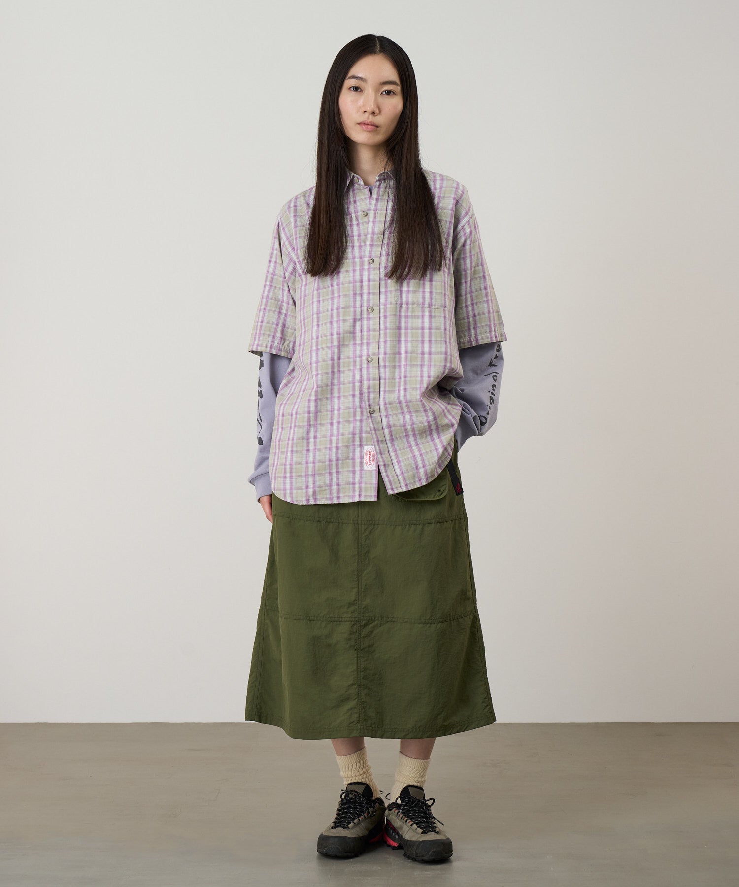 Model wearing Gramicci Nylon Utility Skirt Olive lightweight water-resistant utility skirt lifestyle fit