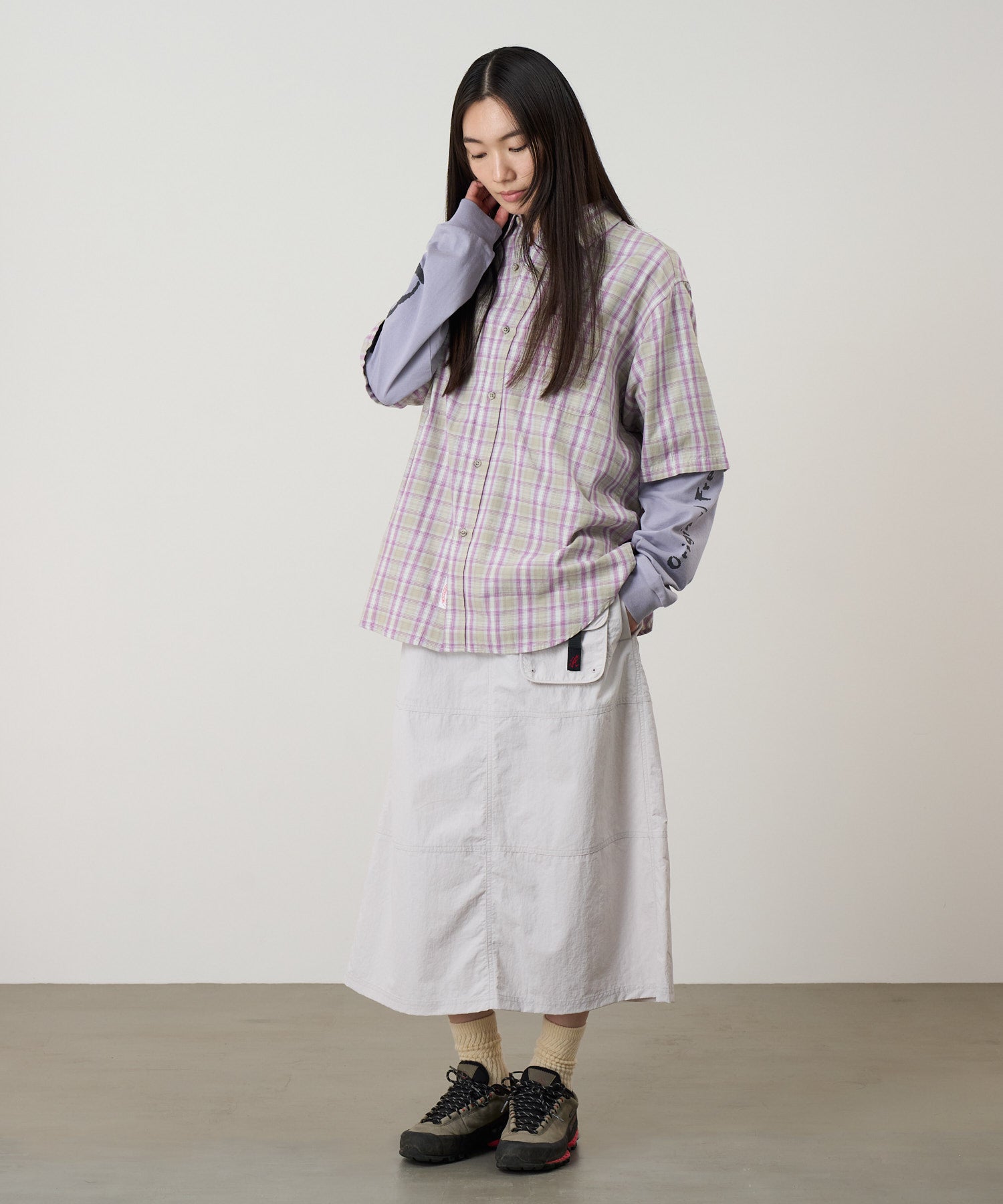 Model wearing Gramicci Nylon Utility Skirt Ecru water-resistant recycled nylon skirt lifestyle fit