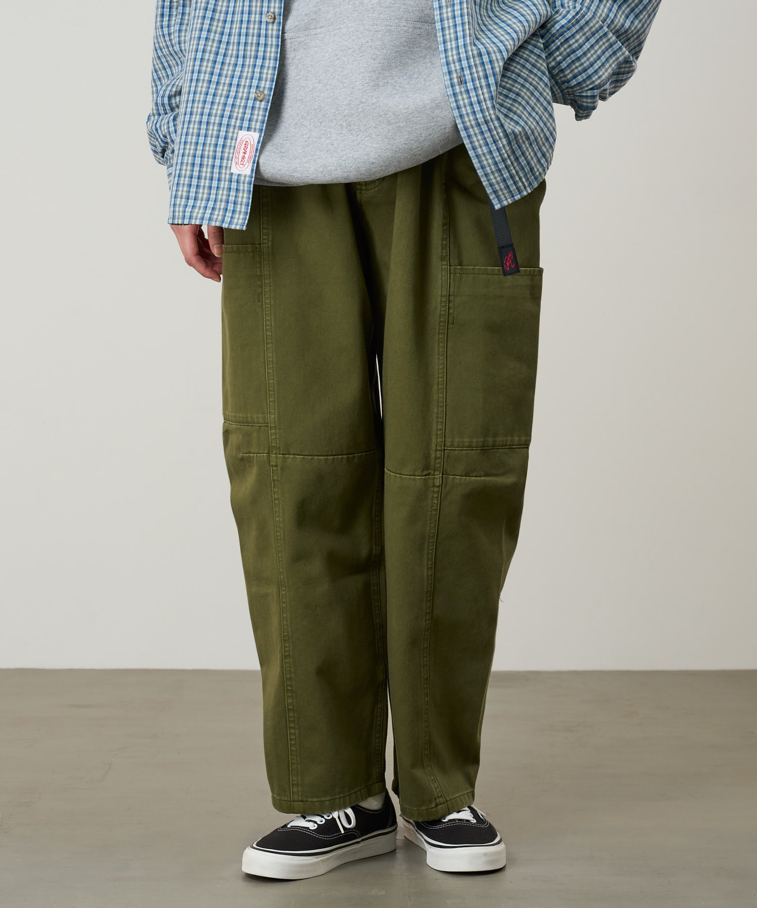 Back view of model wearing Gramicci W’s Voyager Pant Army Pigment relaxed outdoor pants