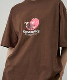 Gramicci Pomegranate Tee Brown worn by model – side view relaxed fit organic cotton graphic t-shirt
