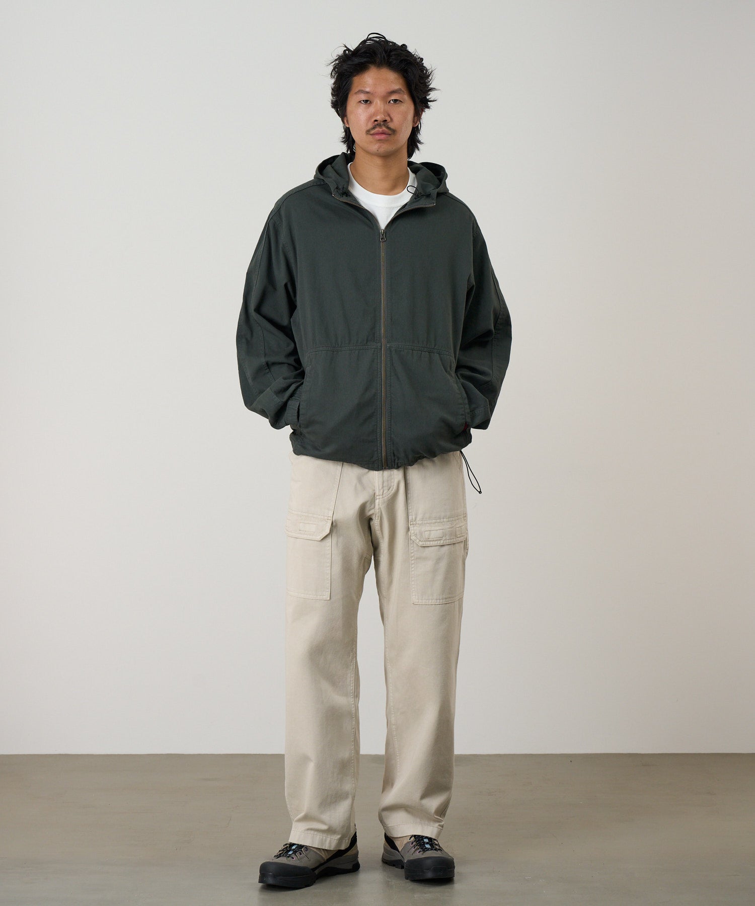 Front view of a model wearing Gramicci Beach Hoodie Jacket Shadow with brushed cotton fabric, drawcord hood and relaxed everyday fit.