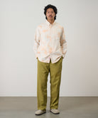 Model wearing Gramicci checkered ombre shirt mustard stripe relaxed fit oxford shirt front view casual style