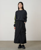 Model wearing Gramicci Convertible Cargo Skirt Black in eco cotton with utility cargo pockets, adjustable fit and versatile everyday style.
