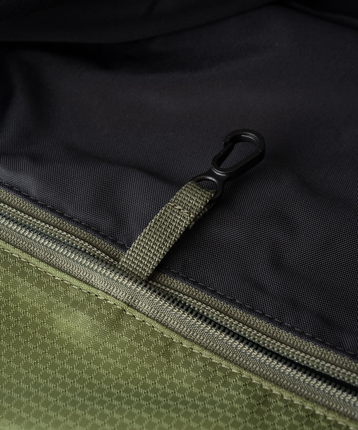 Close-up detail of Gramicci convertible tote backpack olive nylon fabric and strap system showing durability and construction