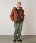 Model wearing Gramicci Gadget Pant Sage in eco cotton washed twill with wrap-around utility pockets