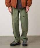 Side view of model wearing Gramicci Gadget Pant Sage in eco cotton washed twill
