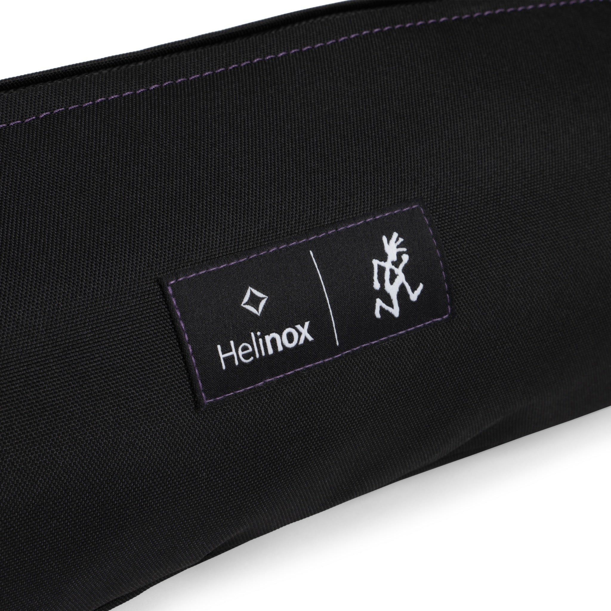 Lifestyle shot of Helinox x Gramicci camping chair in outdoor travel setting