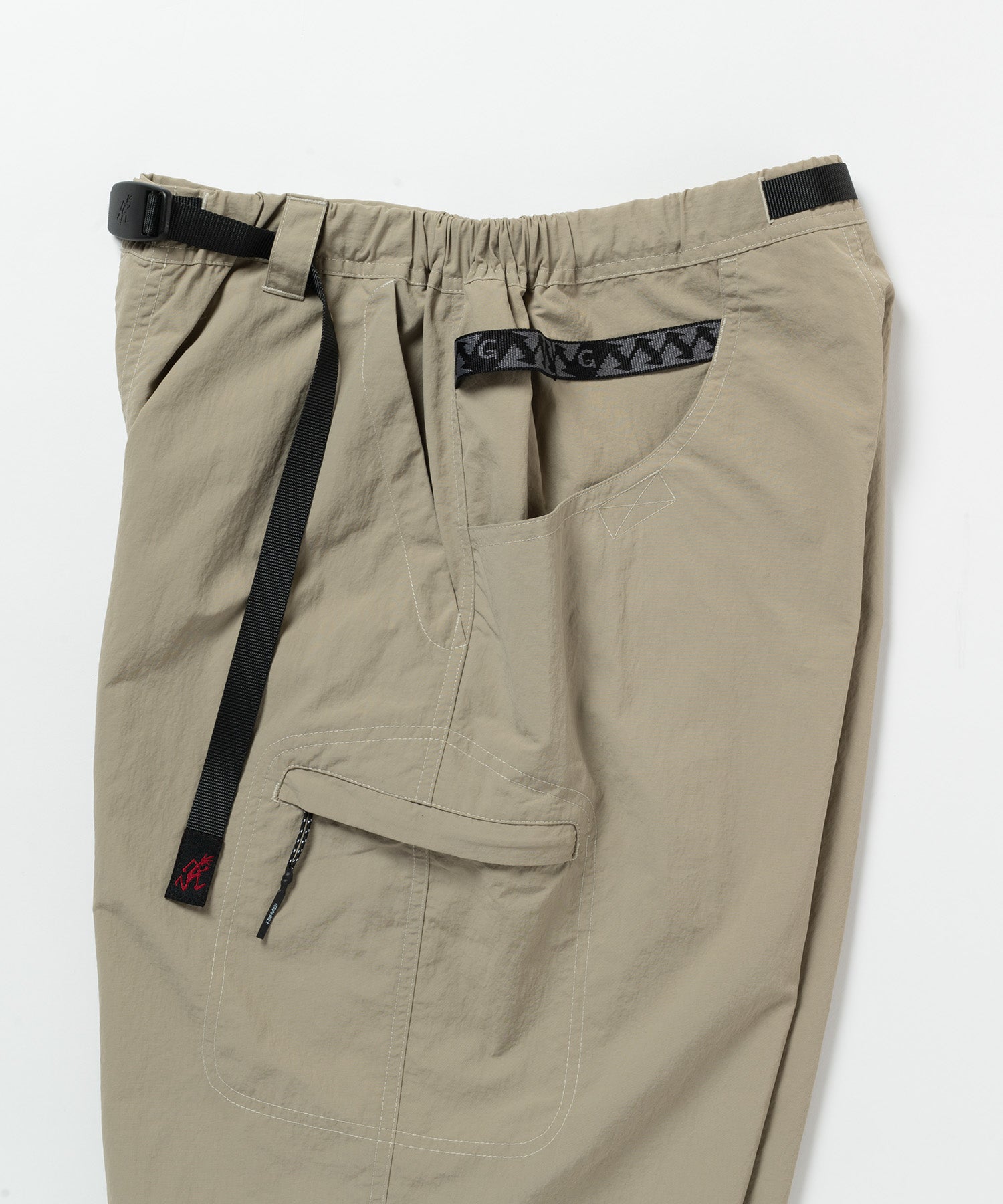 Close-up of Gramicci Nylon Cliff Short Milk Tea featuring the integrated webbing belt and durable recycled nylon construction.