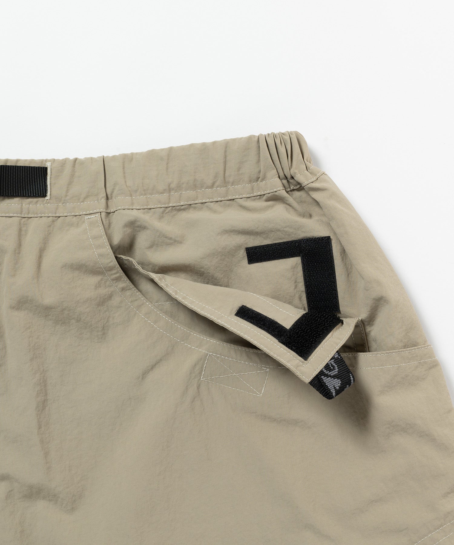 Close-up detail of Gramicci Nylon Cliff Short Milk Tea showing durable recycled nylon fabric and premium construction for everyday wear.