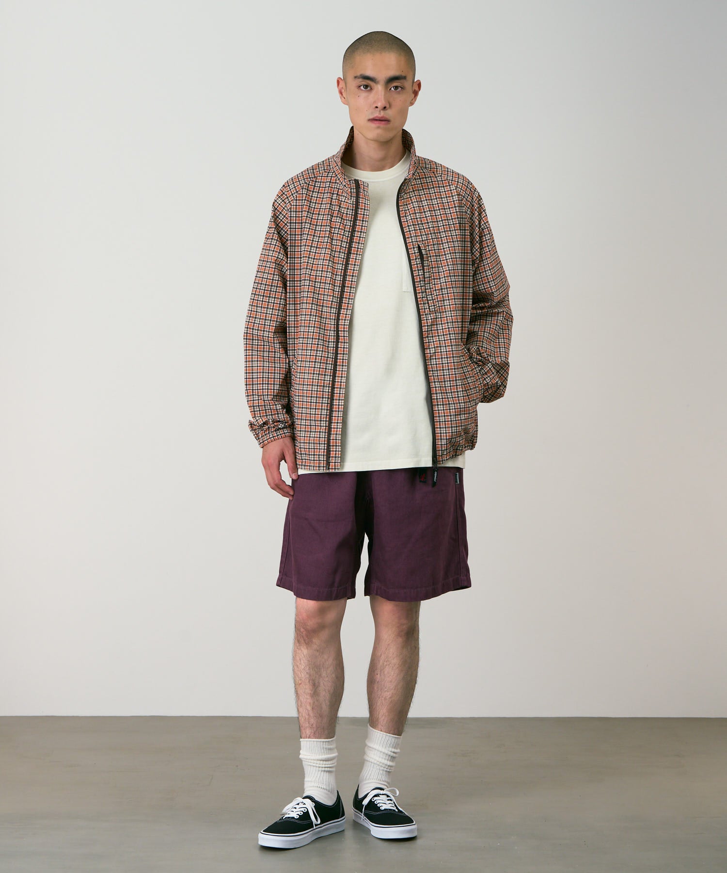 Model wearing Gramicci Nylon Explorer Cargo Shorts Deep Grape relaxed fit outdoor shorts front view lifestyle