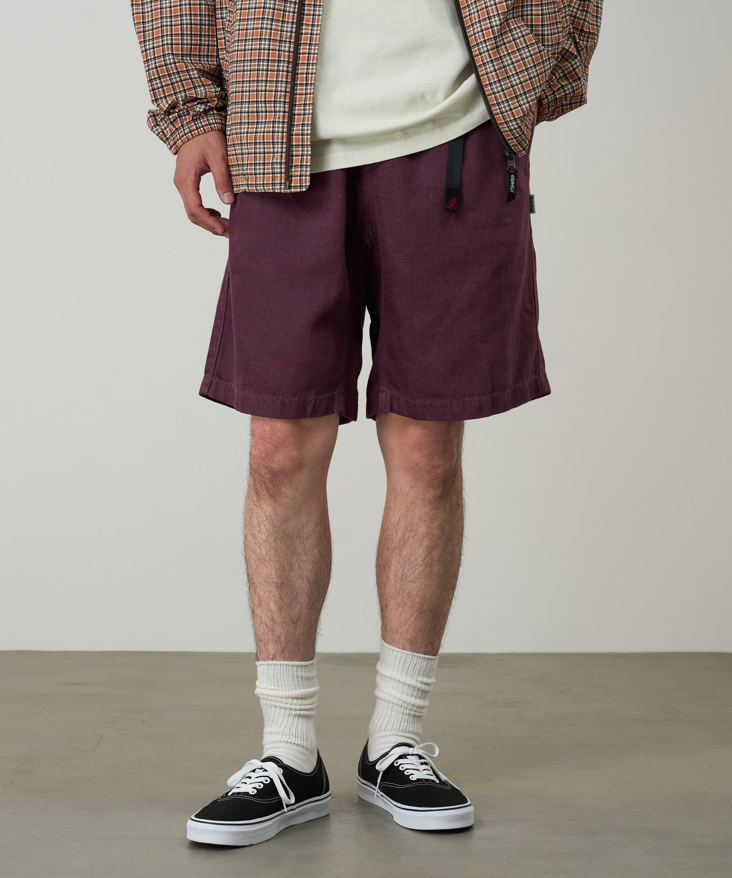 Side view of model wearing Gramicci Nylon Explorer Cargo Shorts Deep Grape relaxed fit outdoor shorts lightweight utility style