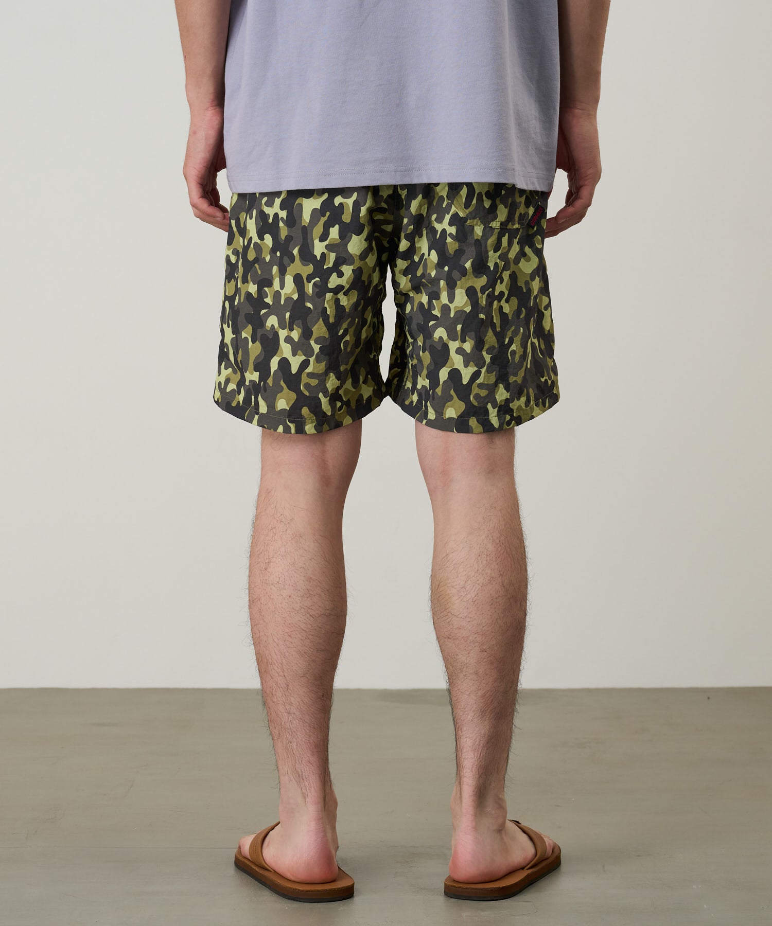 Gramicci Nylon Reef Short Olive Camo on model side view – quick-dry water-resistant shorts with elastic waist for beach and outdoor wear
