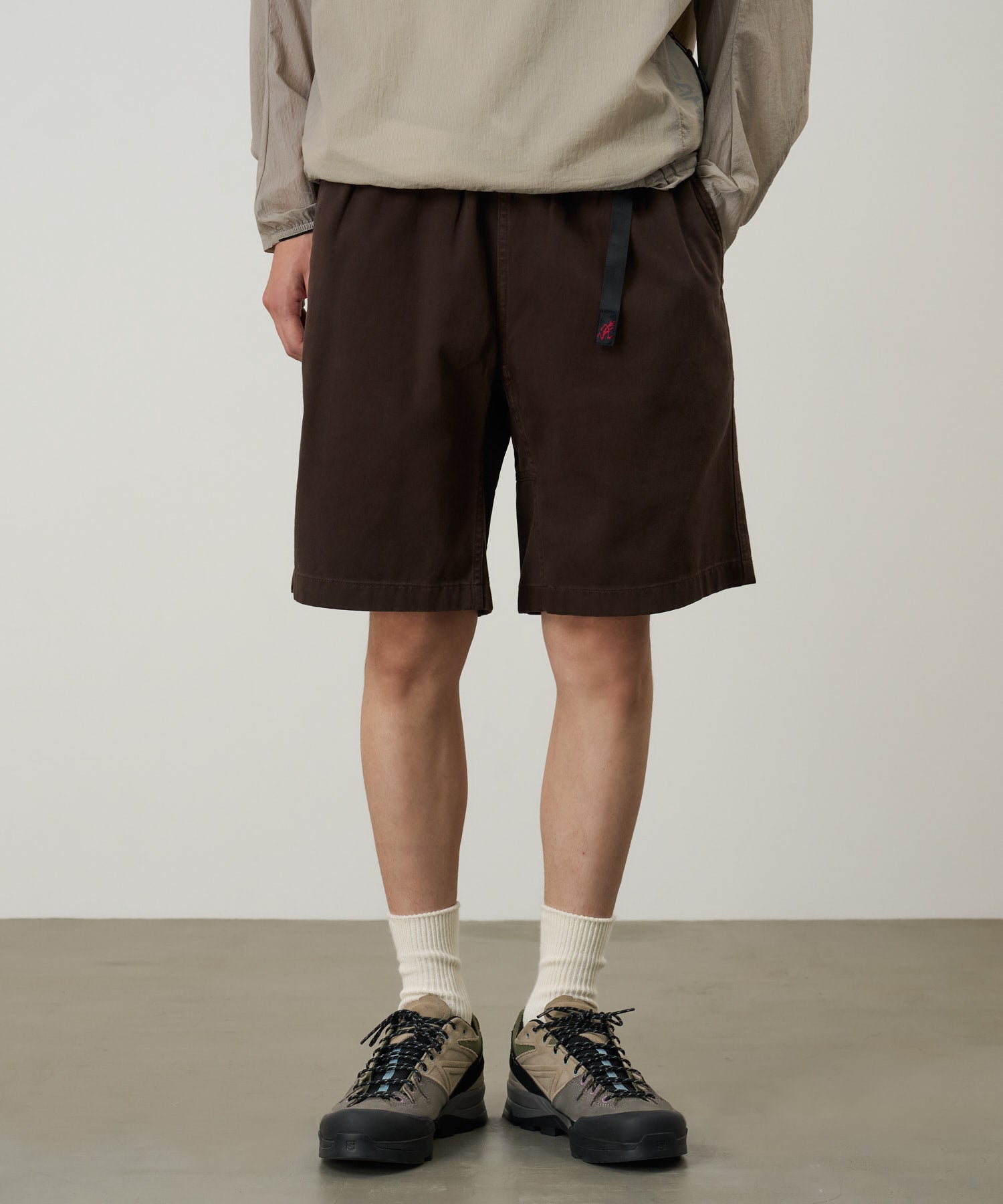 Model wearing Gramicci OGT shorts in chocolate brown