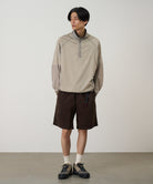 Model wearing Gramicci OGT chocolate brown shorts relaxed fit
