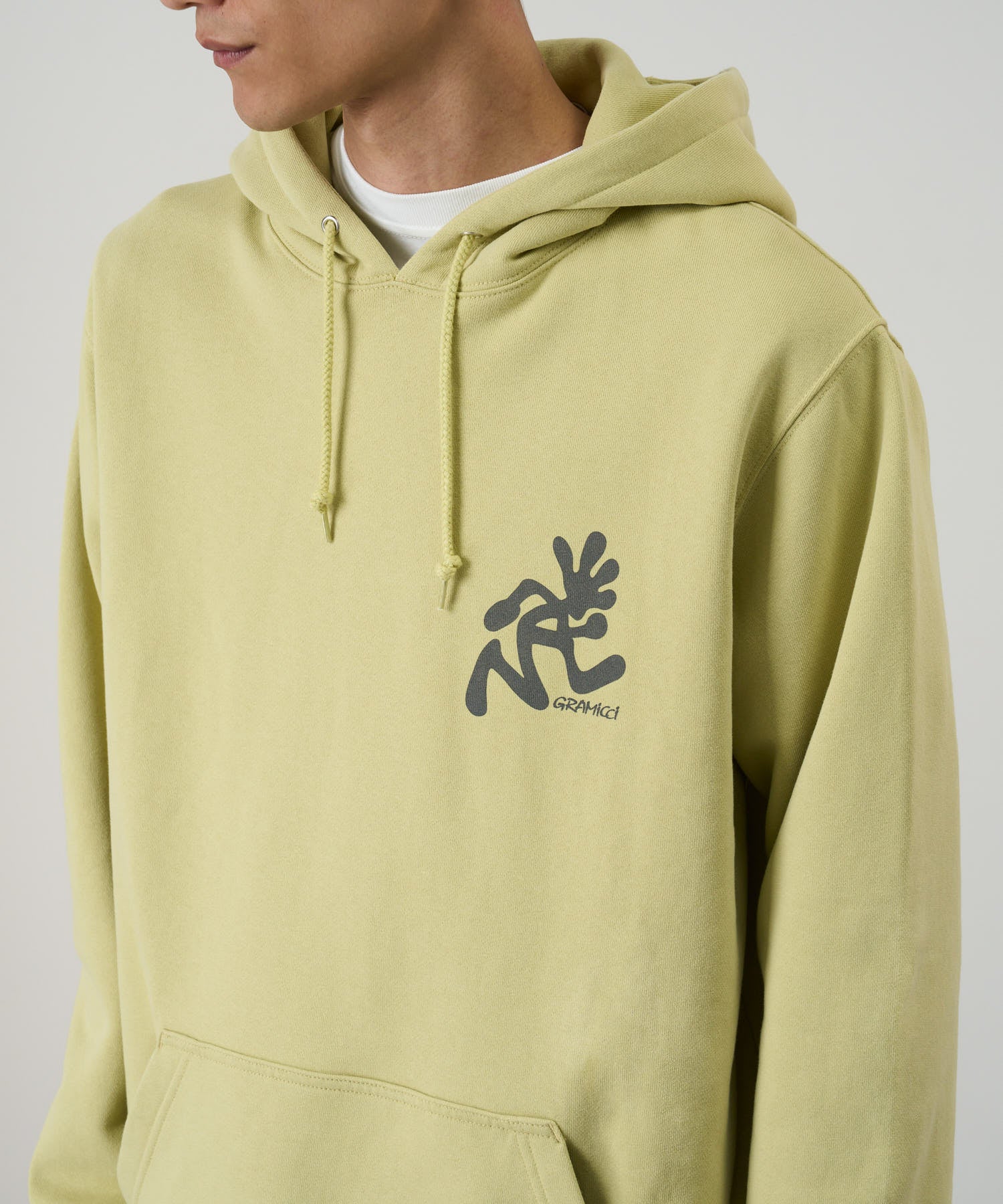 Gramicci Running Man Hooded Sweatshirt Lime on model side view – relaxed fit cotton-blend hoodie for casual wear, layering, and streetwear style