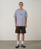 Front view of a model wearing Gramicci Turtle Tee Lavender made from eco cotton with a soft dry-touch finish and relaxed everyday fit.