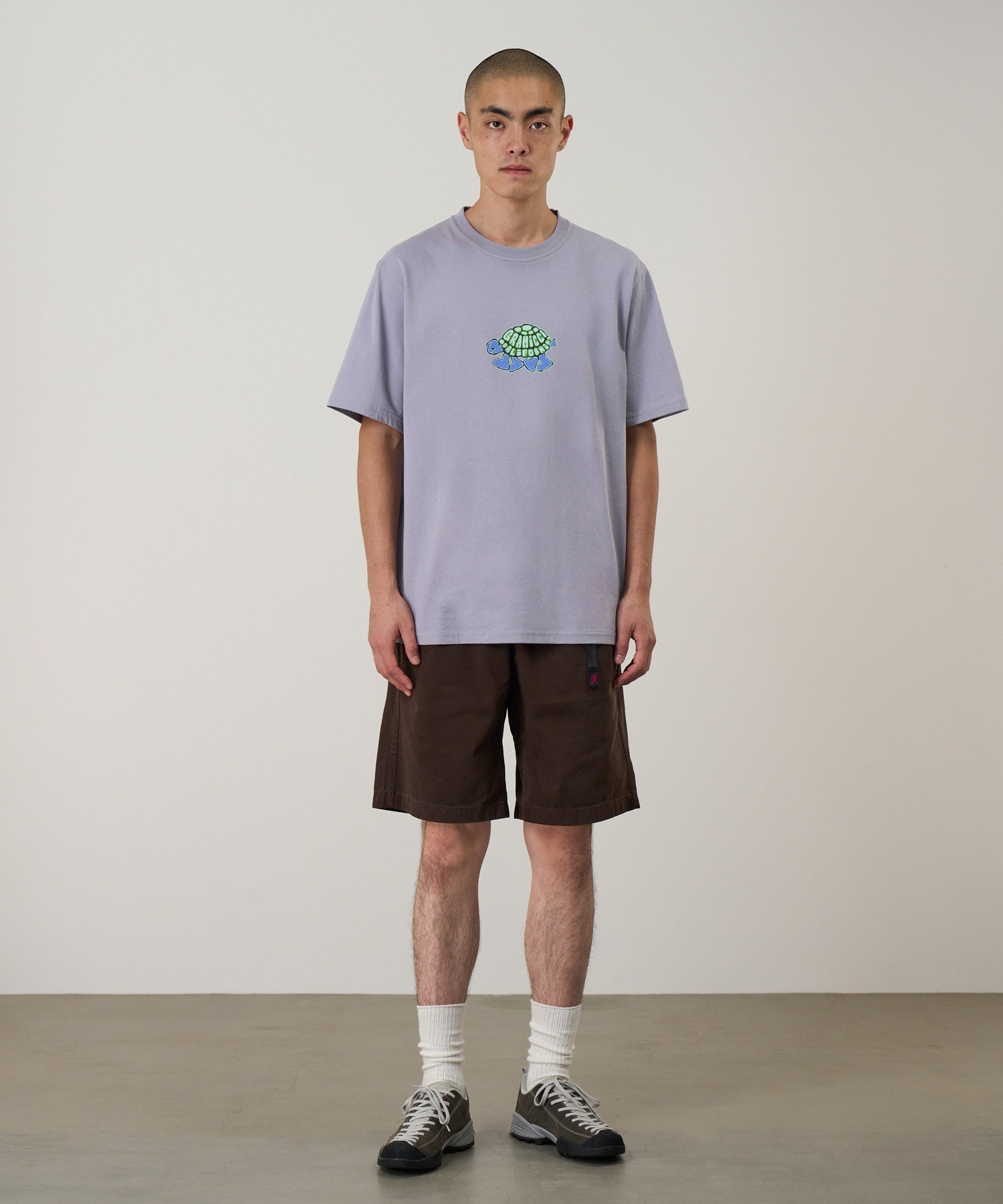 Front view of a model wearing Gramicci Turtle Tee Lavender made from eco cotton with a soft dry-touch finish and relaxed everyday fit.