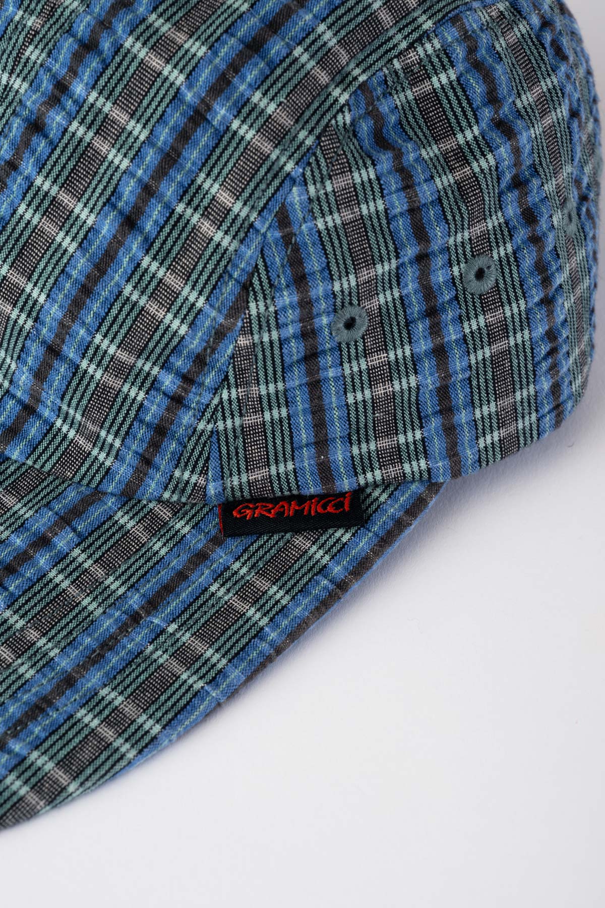 Close-up of Gramicci Long Bill Cap Multi Stripe showing breathable cotton seersucker fabric texture