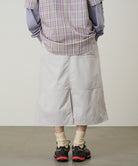 Model wearing Gramicci Nylon Utility Skirt Ecru water-resistant recycled nylon skirt lifestyle fit
