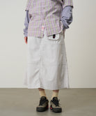 Model wearing Gramicci Nylon Utility Skirt Ecru water-resistant recycled nylon skirt