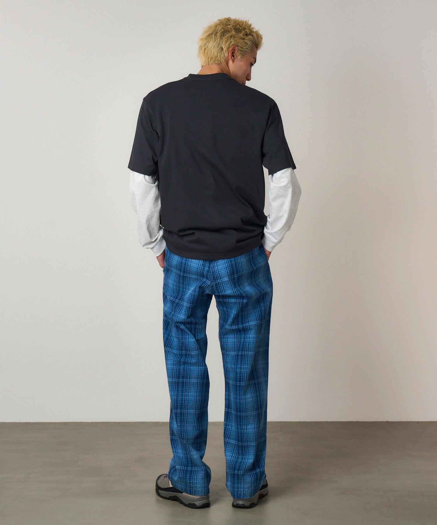 Model wearing Gramicci O.G. denim plaid pant indigo checkered relaxed fit back view straight leg trousers