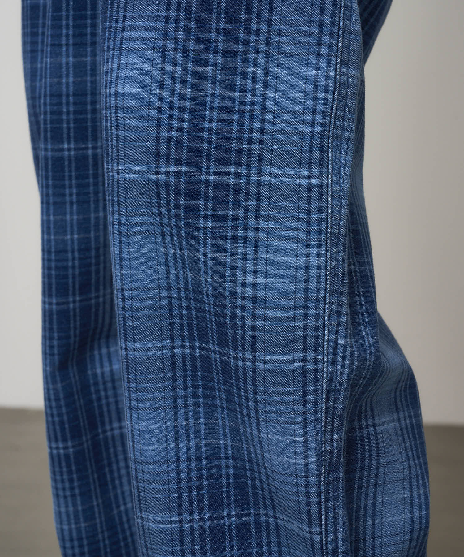 Close-up detail of Gramicci O.G. denim plaid pant indigo checkered showing fabric texture and stitching