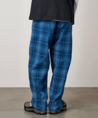 Model wearing Gramicci O.G. denim plaid pant indigo checkered showing full relaxed straight fit and movement
