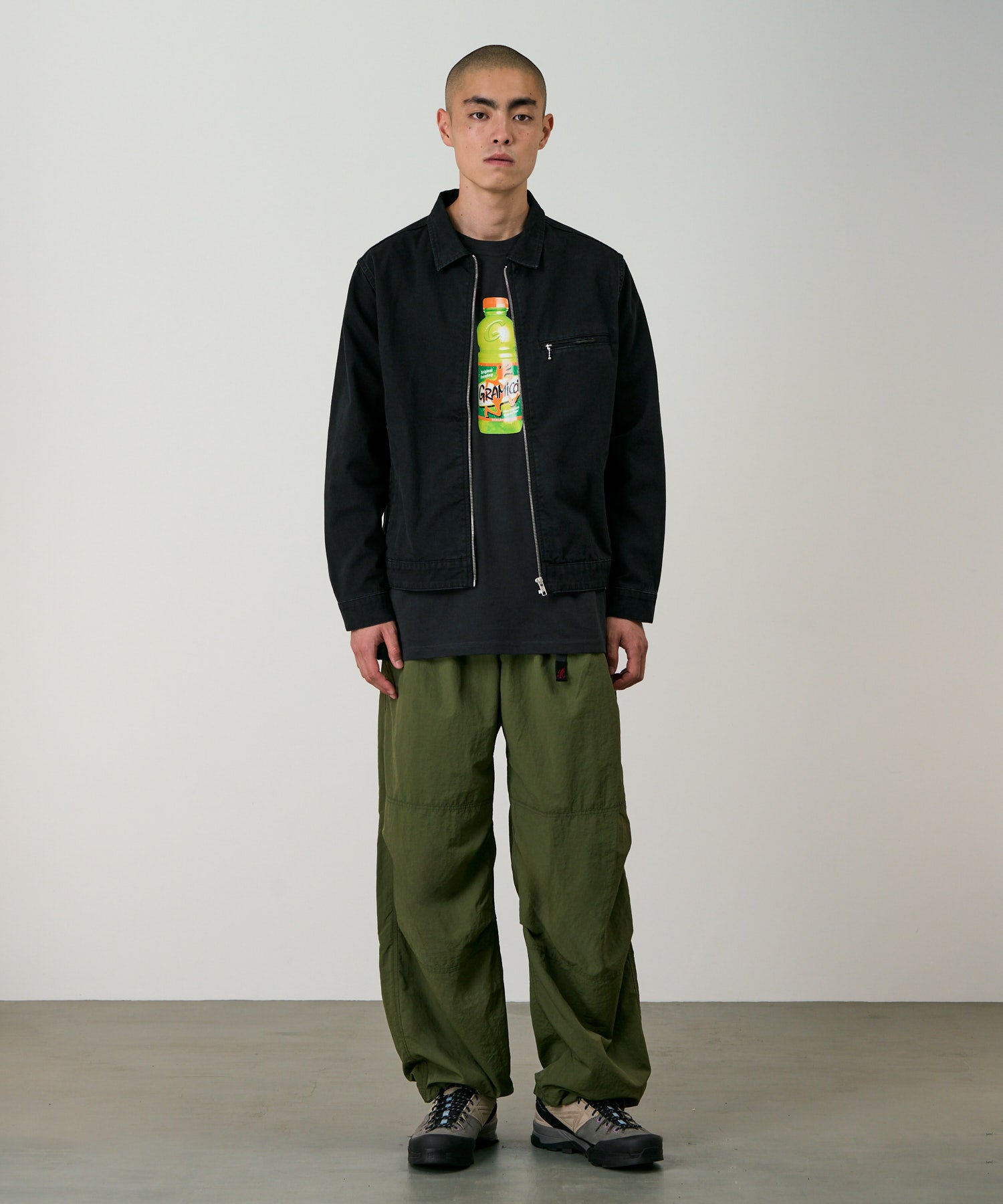 Model wearing Gramicci olive nylon trek pants showing relaxed outdoor fit