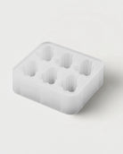 Detail view of Gramicci Running Man Ice Cube Tray showing silicone mold cavities used to create branded ice cubes in glacier color