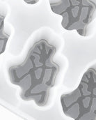 Lifestyle view of Running Man Ice Cube Tray in glacier made from 100% food-grade silicone showing ice cubes shaped with Gramicci logo for drinks