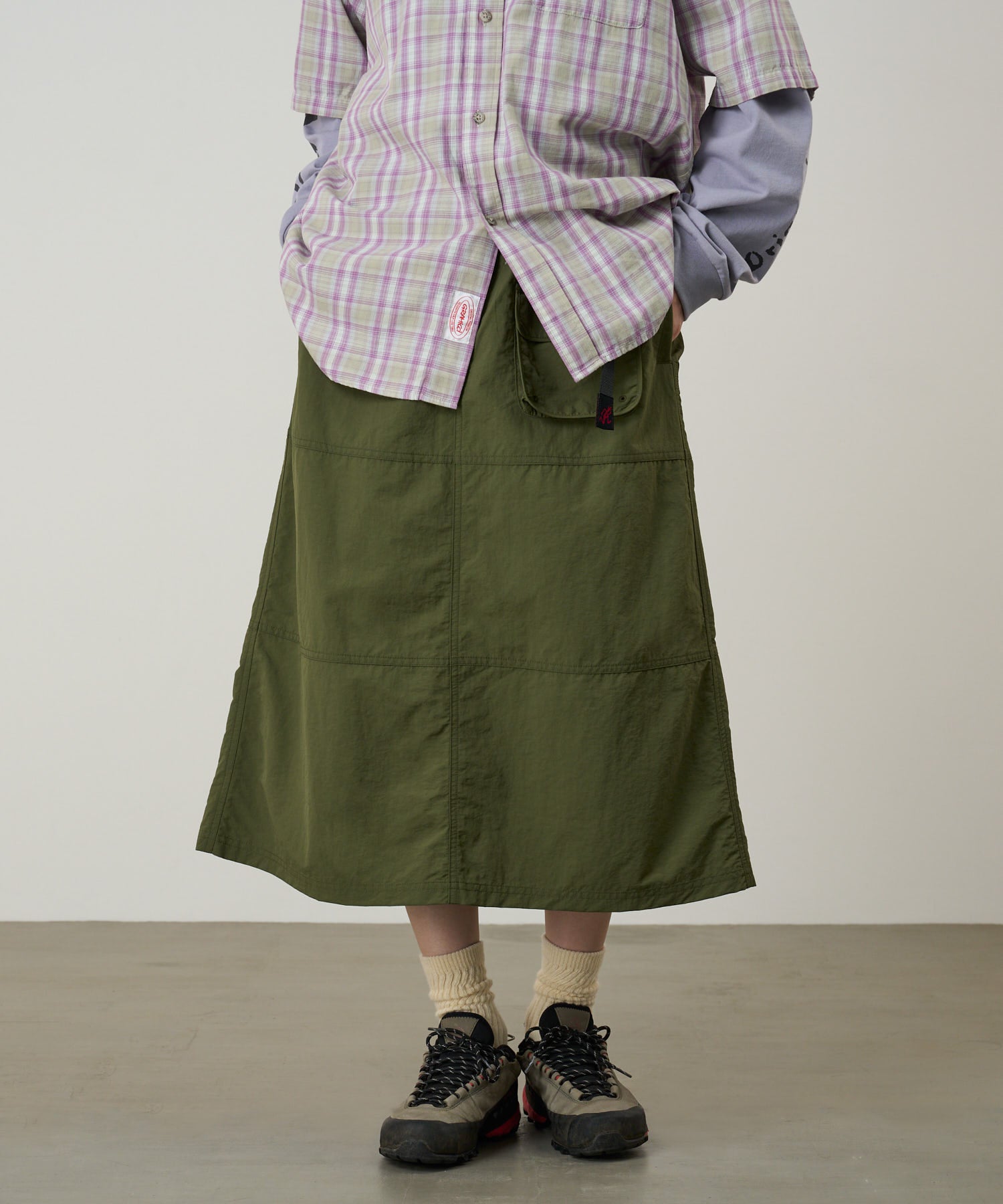 Model wearing Gramicci Nylon Utility Skirt Olive lightweight water-resistant utility skirt